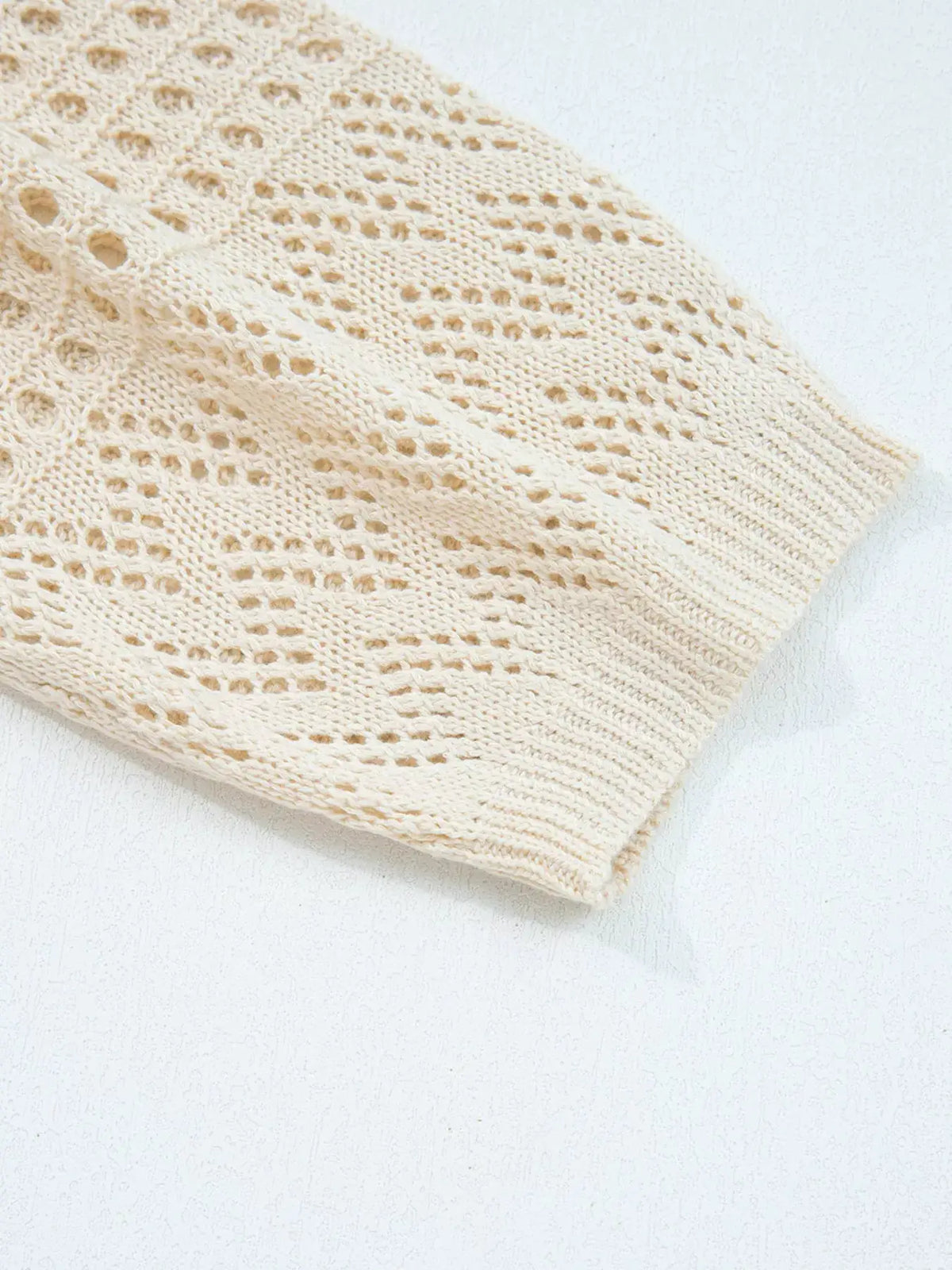 Hollowed knit open-front cardigan with side pockets in cream by Trendsi