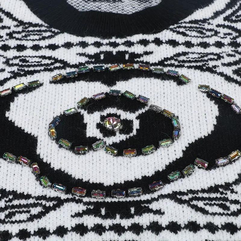 Women's soft-knit pullover sweater in black-and-white Nordic pattern; includes a multicolored beaded necklace and ring.