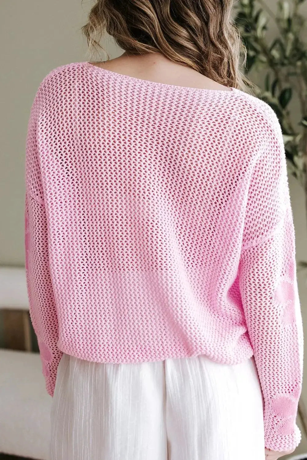 Lightweight openwork floral knit cover-up top in soft pink, round-neck, back view