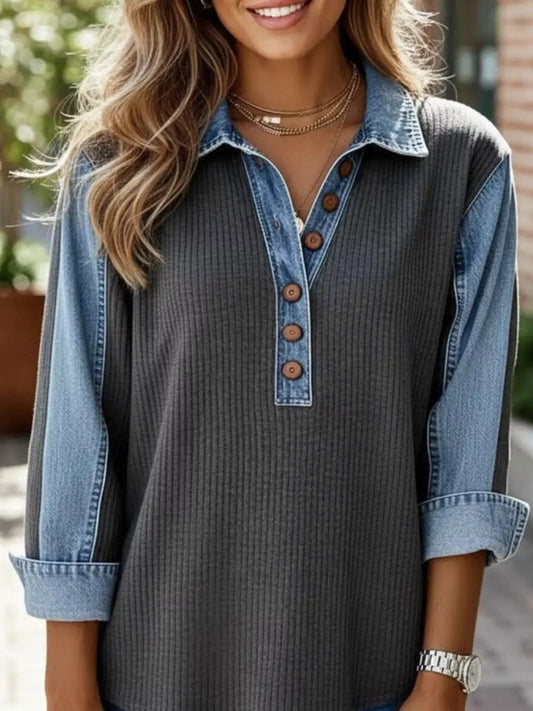 Denim-trim button-detail sweatshirt with a dark rib-knit body and light blue denim sleeves.