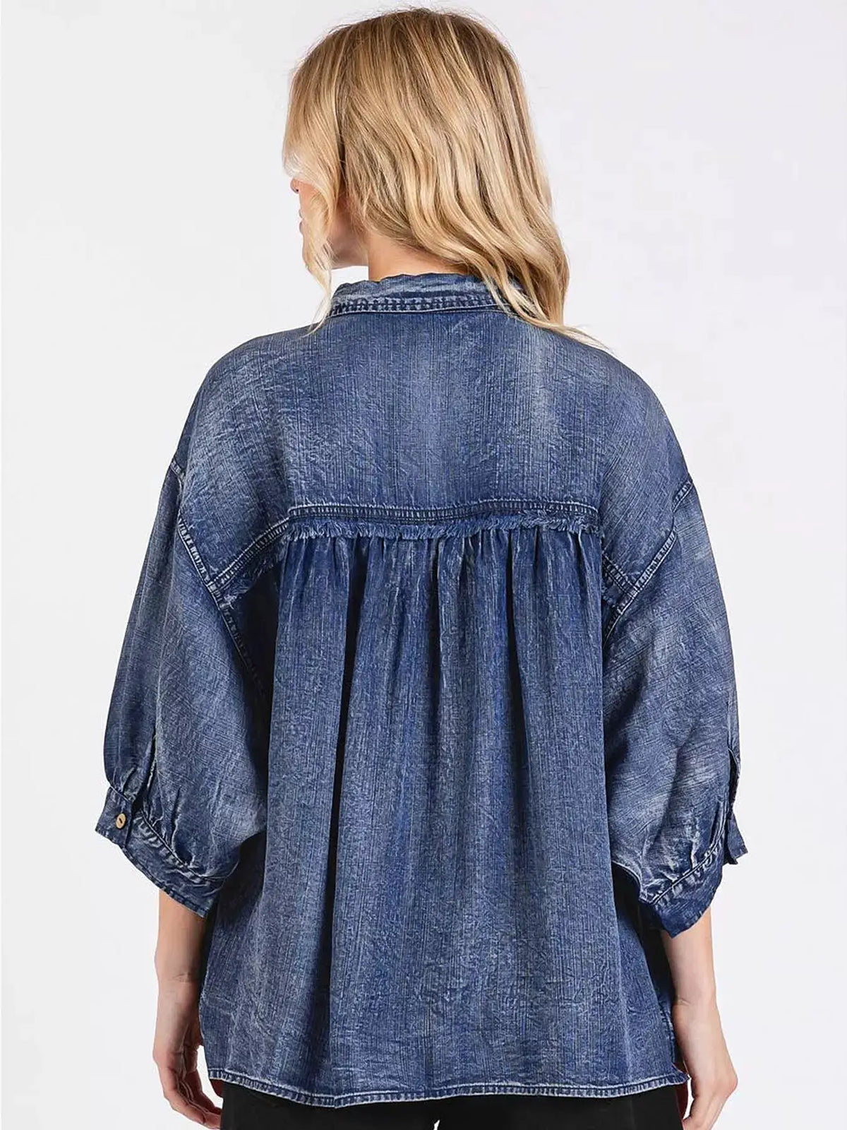 Relaxed denim shirt back view in blue wash with gathered yoke and 3/4 sleeves