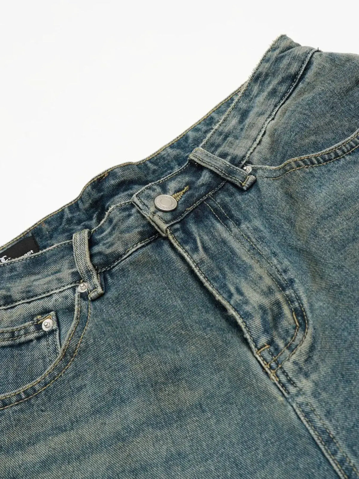 Men's blue denim shorts waistband close-up with belt loops and metal button