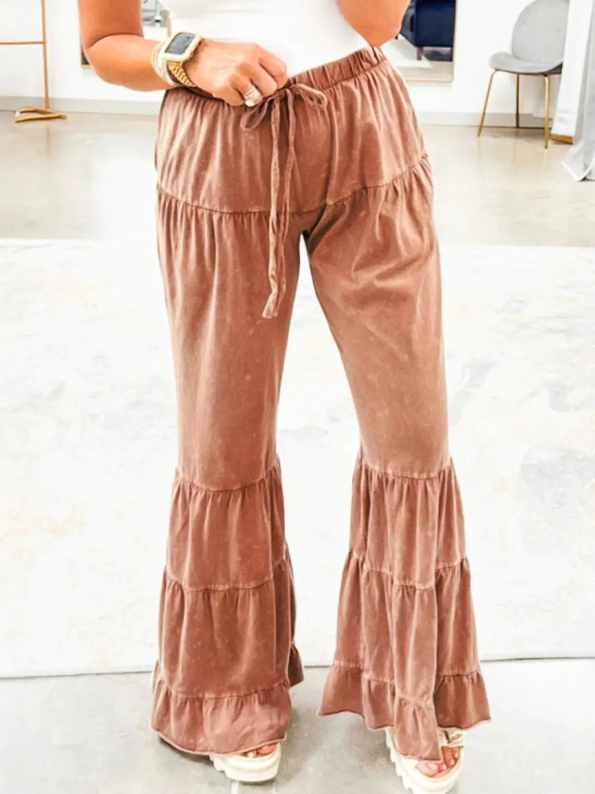 Drawstring flare ruffle palazzo pants in brown velvet with tiered ruffle hems.
