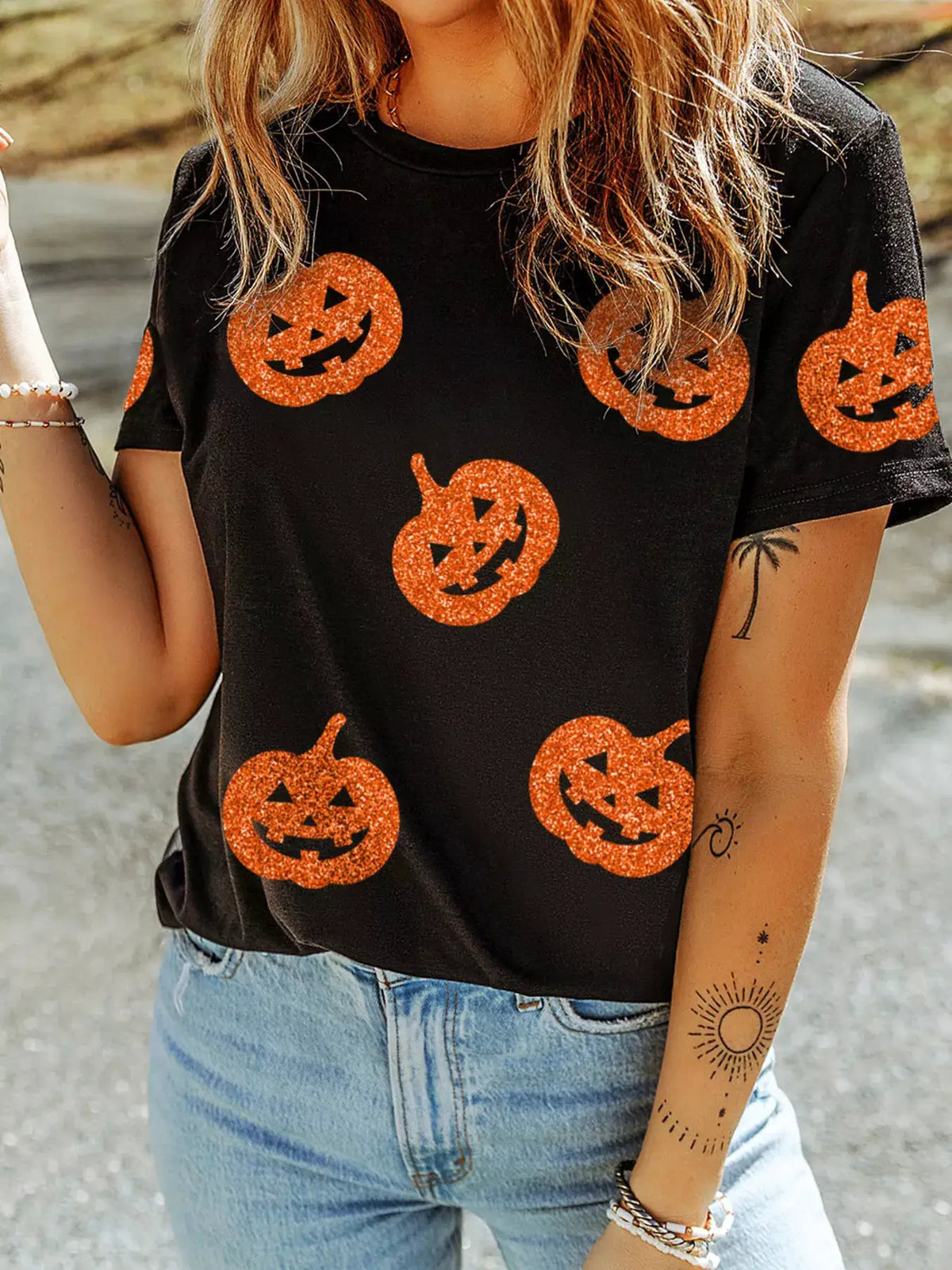 Glittering Pumpkin Face Crewneck T-Shirt in black with orange glitter jack-o'-lanterns by Trendsi