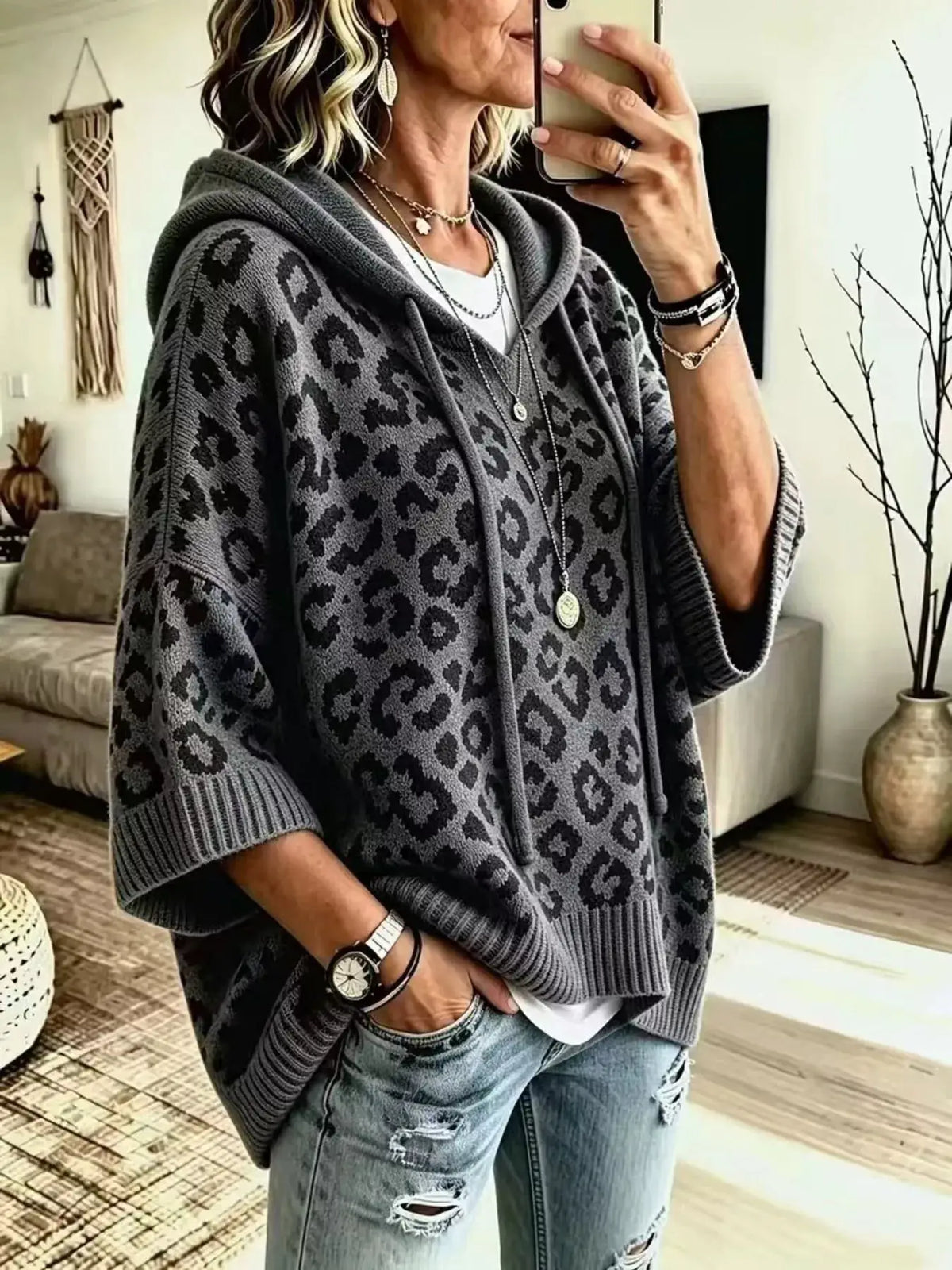 Drawstring leopard-print gray hoodie sweater; oversized knit with ribbed cuffs and hem.