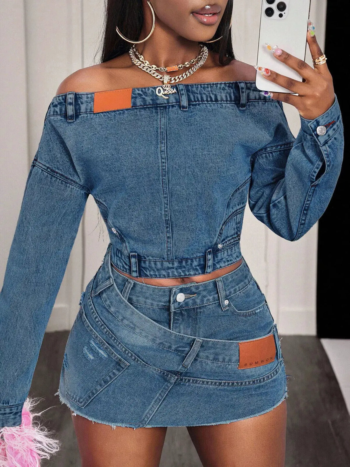 Women off-shoulder stretch denim top with long sleeves and front buttons in blue; orange patch.