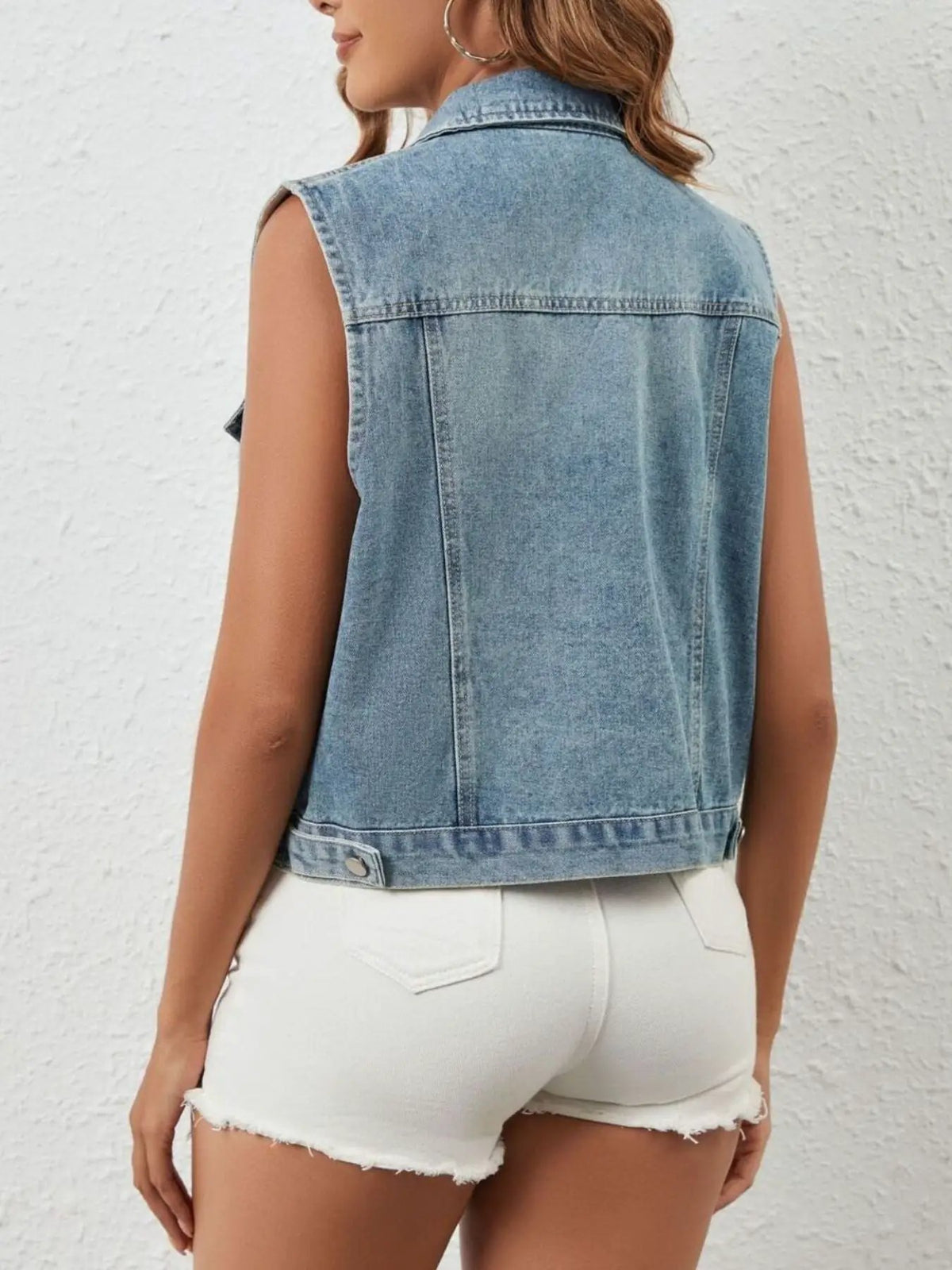 Rhinestone sleeveless denim jacket with button-front; light-wash denim