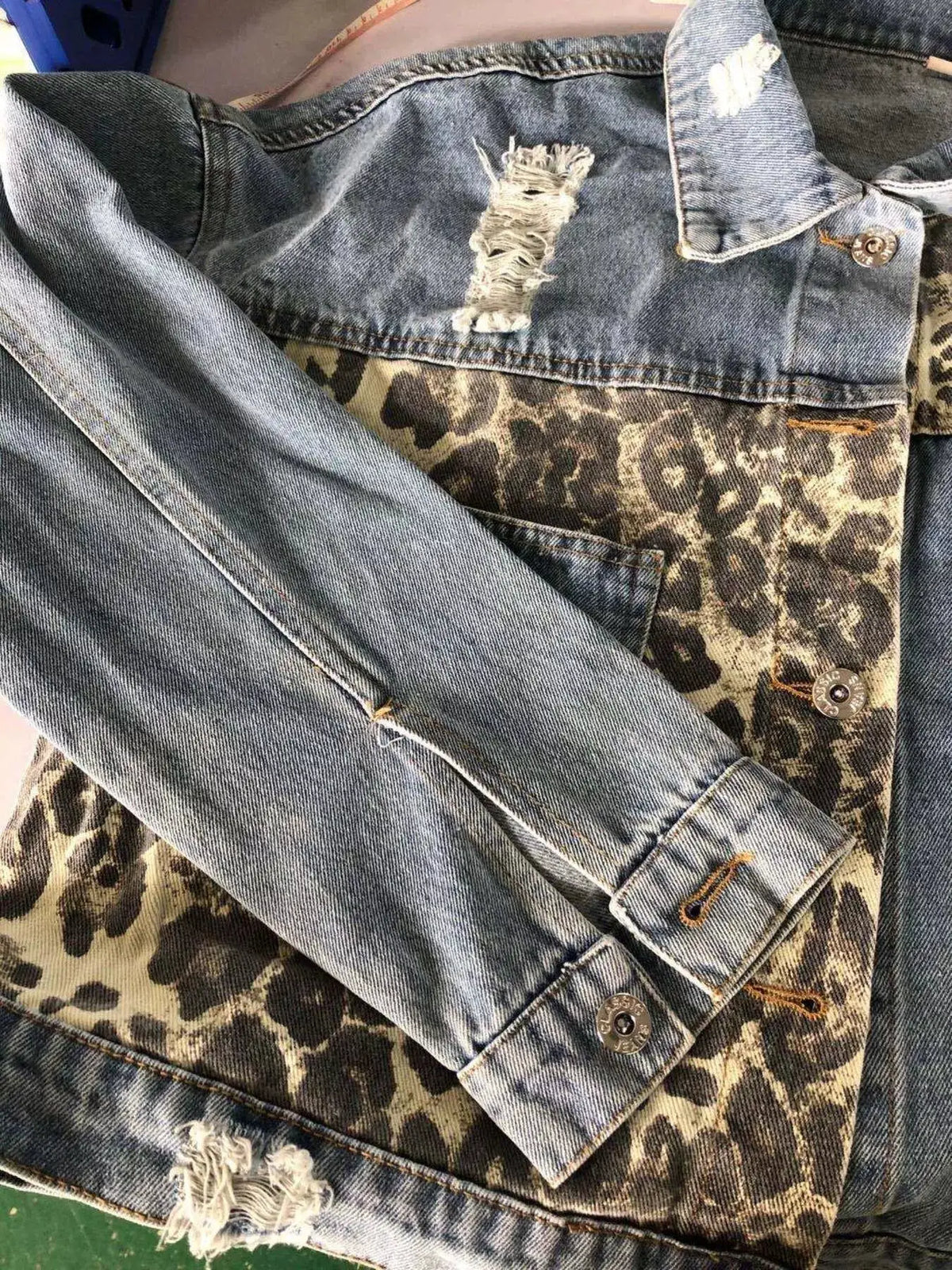 Leopard print distressed denim jacket by Trendsi with button-front casual outerwear.