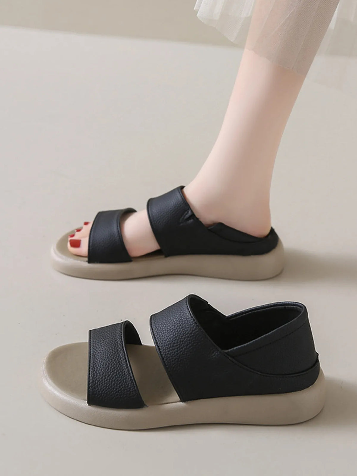 Open toe platform sandals, black faux leather, two-strap design with beige sole; two pairs shown.