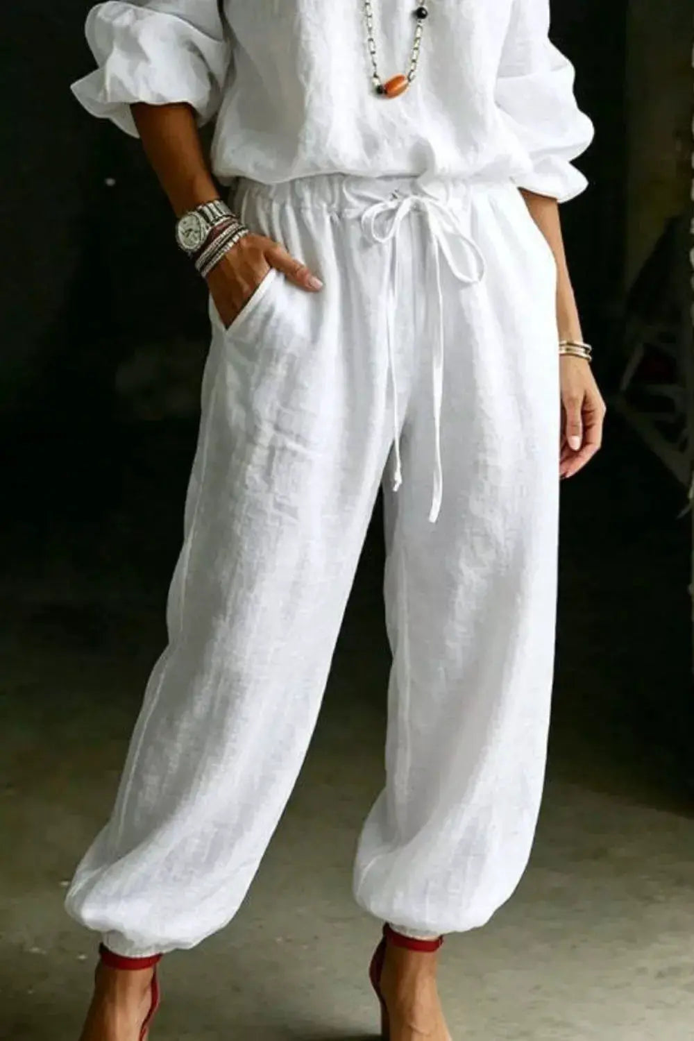 Trendsi plus-size white off-shoulder top and pants set; linen-like fabric with drawstring waist and cuffed ankles.