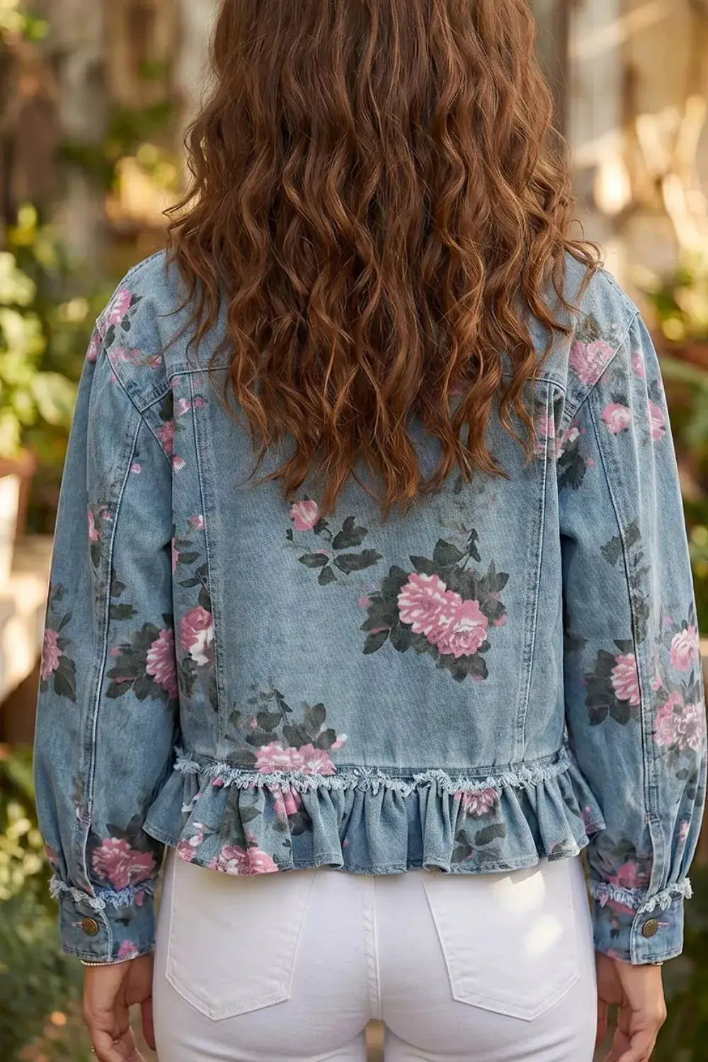 Women's floral print denim jacket with a delicate ruffled hem in light-wash blue.
