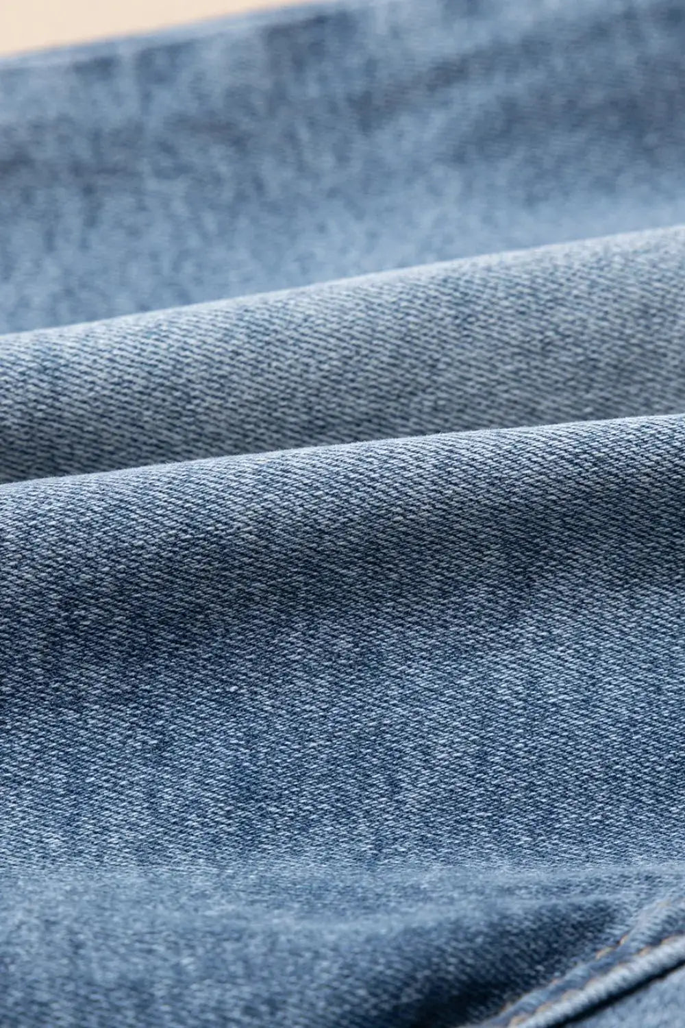 Denim shorts fabric close-up in washed blue cotton blend
