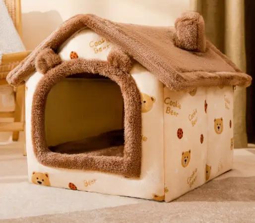 Foldable pet house bed in beige fabric with brown plush trim and bear print, enclosed cave-style shelter.