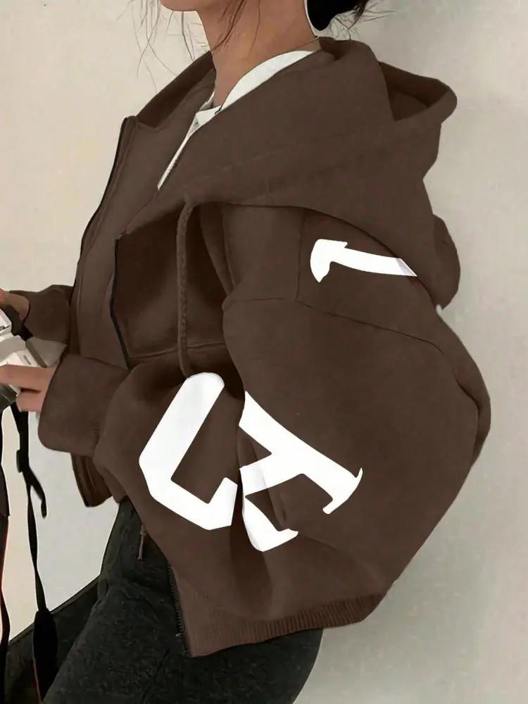 Soft full-zip brown sweatshirt with oversized sleeves and white graphic on sleeve