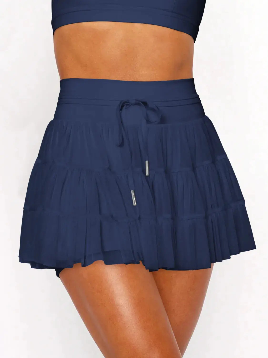 Ruched mini skort with pockets in navy blue; tiered ruffle panels and drawstring waist