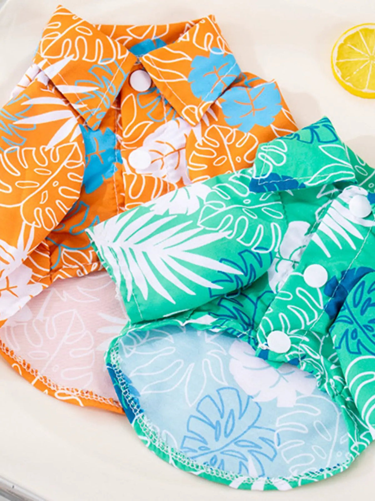 Lightweight Pet Tops set of 3 by Trendsi; tropical leaf prints in orange, teal, and green with white buttons.