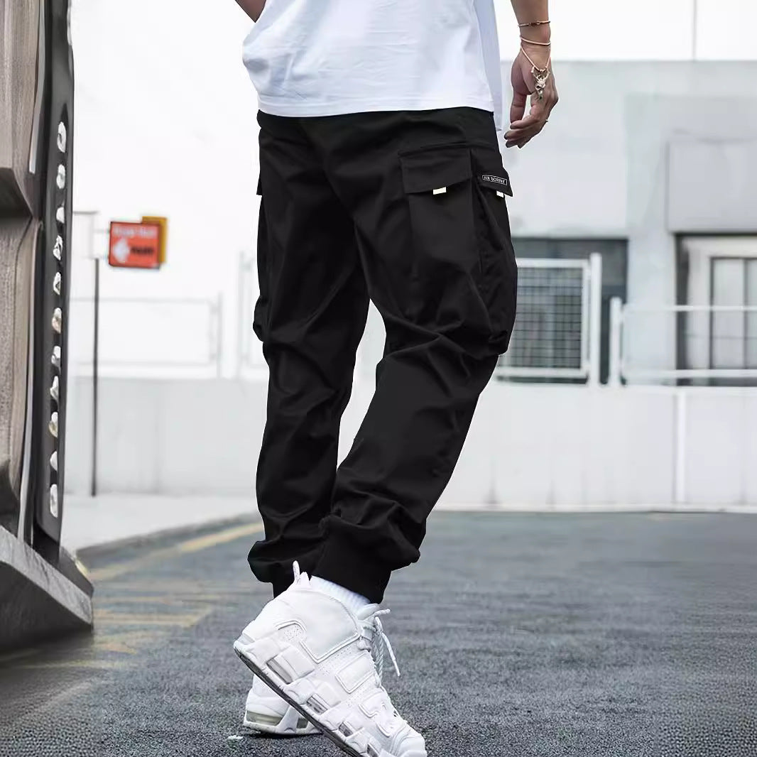 Multi-pocket cargo pants for men, black AdTec trousers with large side pockets.