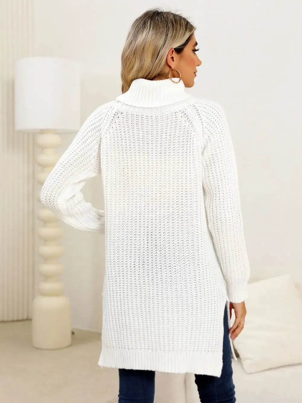 Womens white knit pullover sweater with turtleneck, long sleeves and side slit.