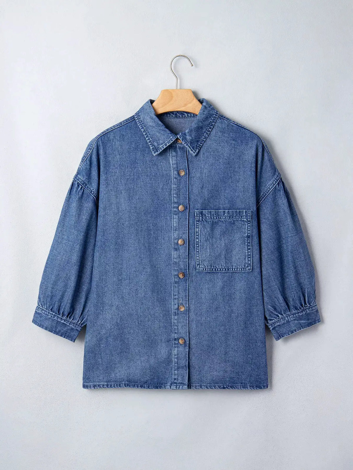 Trendsi relaxed denim shirt with three-quarter sleeves and front chest pocket in blue wash.