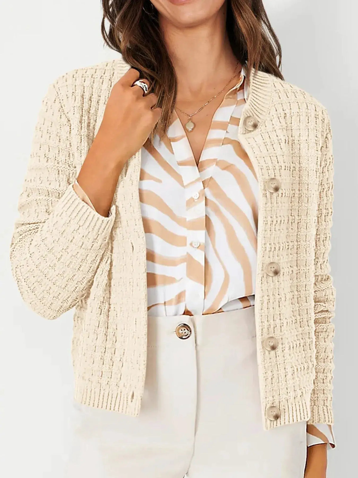 Textured stretchy knit button-front cardigan by Trendsi in cream, worn over a beige zebra-print blouse.