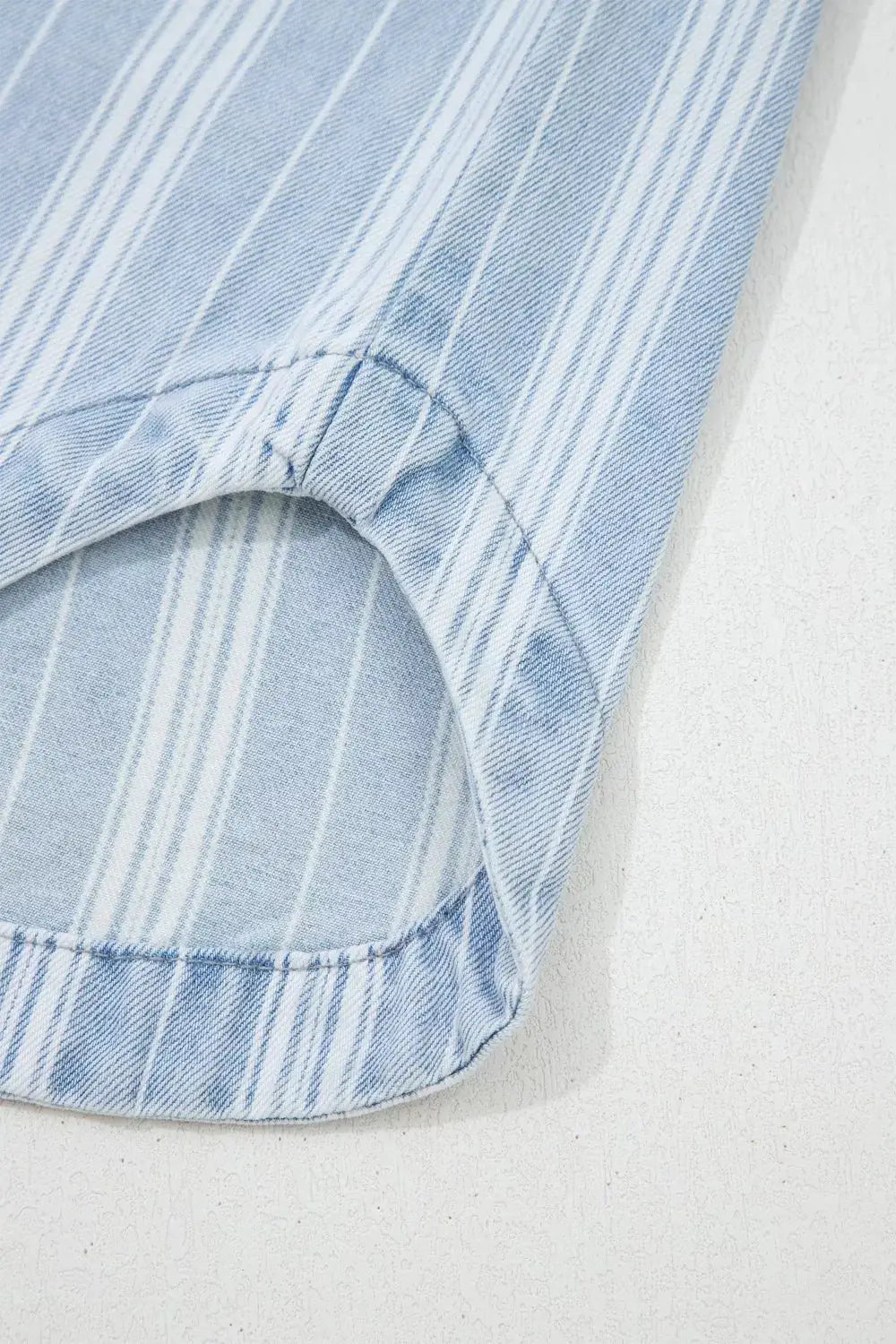 Striped denim shacket sleeve in light blue with white stripes and curved hem