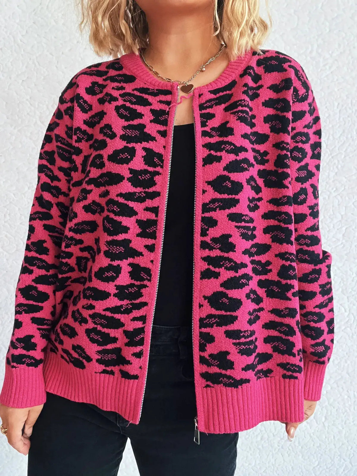 Zip-up long-sleeve cardigan in hot pink with black leopard print, ribbed cuffs and hem