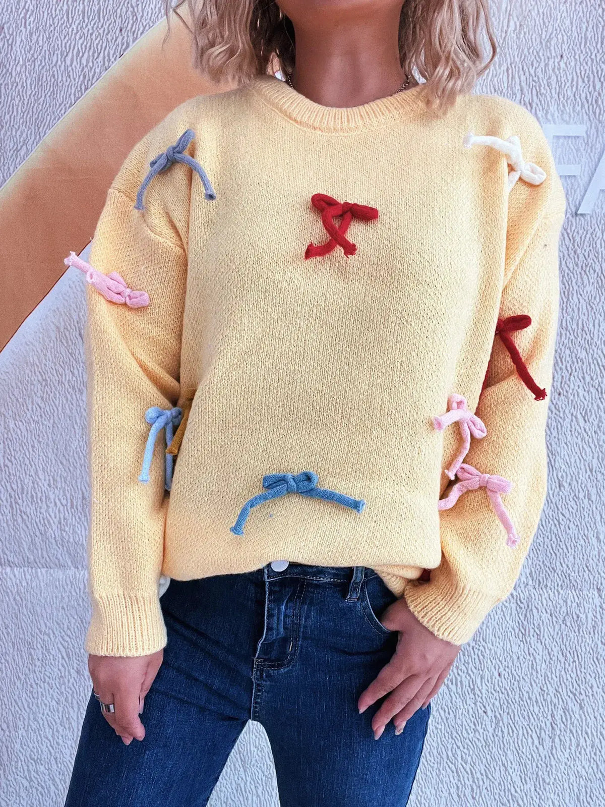 Vibrant bow-accent round-neck knitted sweater for women in yellow with colorful ribbon bows, Trendsi