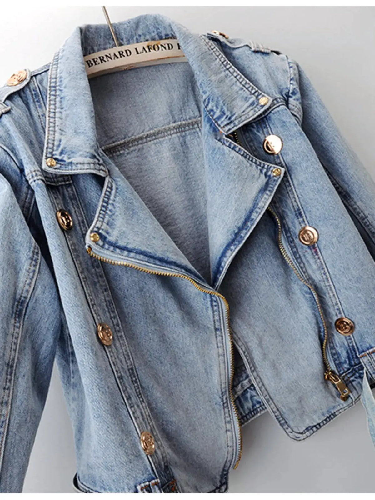 Denim jacket with asymmetrical zip front and belted waist in blue wash with gold hardware