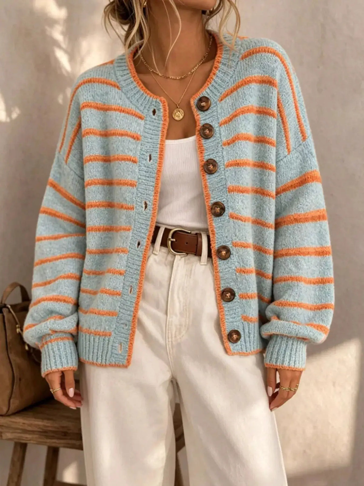 Striped button-down knit cardigan in light blue with orange stripes, button-front