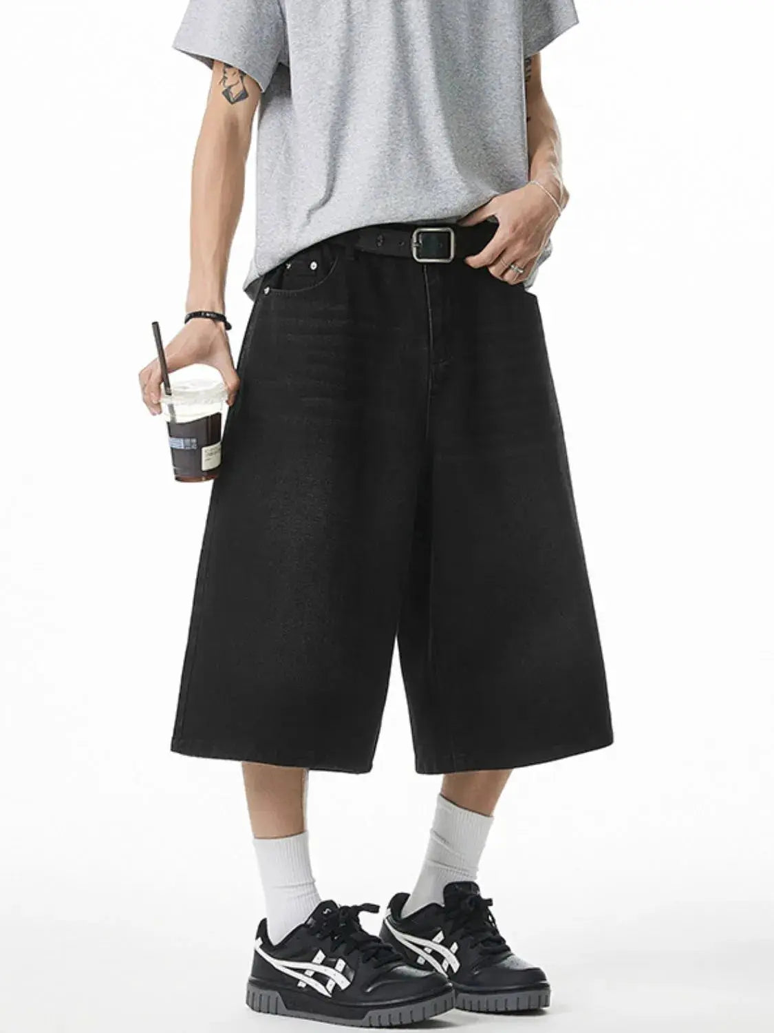 Men's plus-size stretchy denim shorts in black with deep pockets by Trendsi
