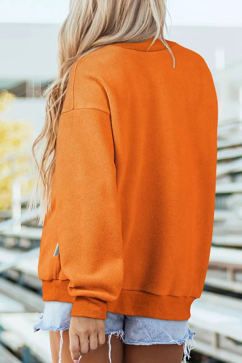 Spooky Season Reversible Halloween Sweatshirt in orange, back view with ribbed cuffs and hem