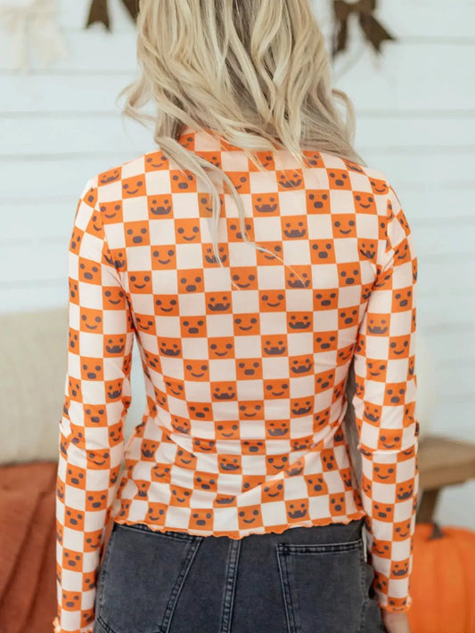Abstract Halloween Pattern Long Sleeve Mock Neck Blouse in orange-and-white checkerboard.