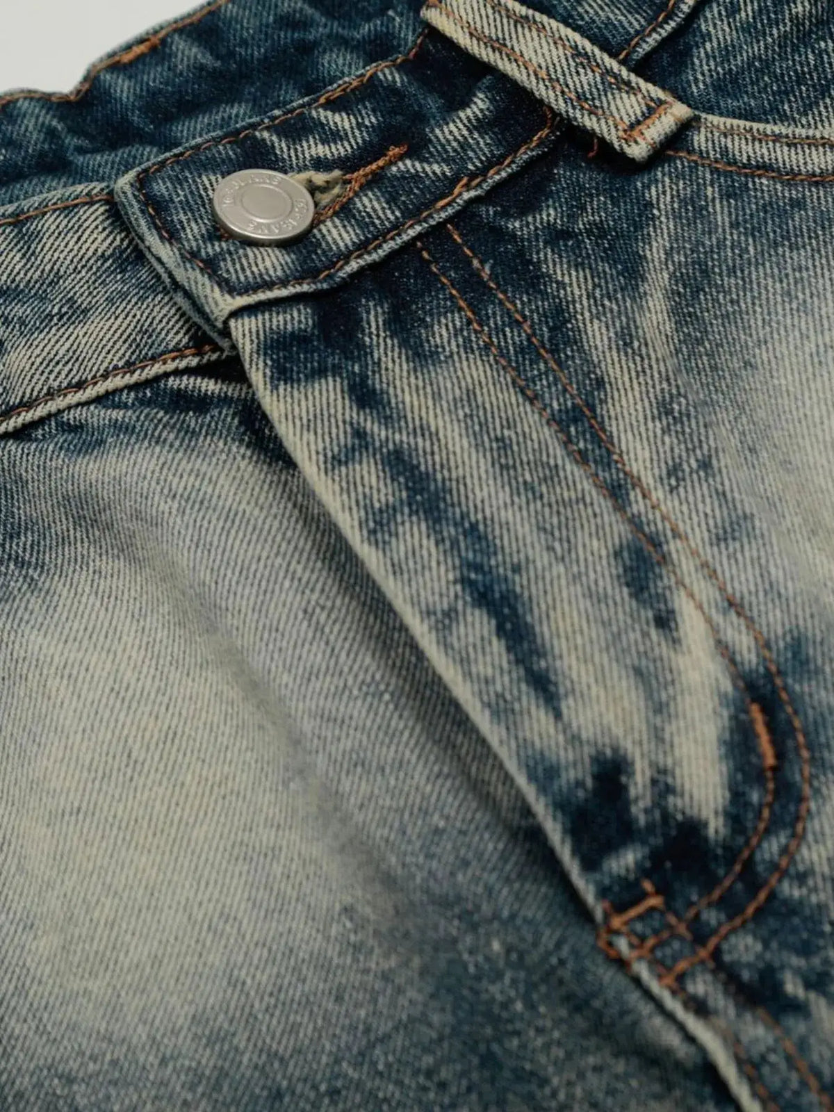 Men's acid-wash denim shorts with stretch cotton blend; close-up of metal button and orange topstitching