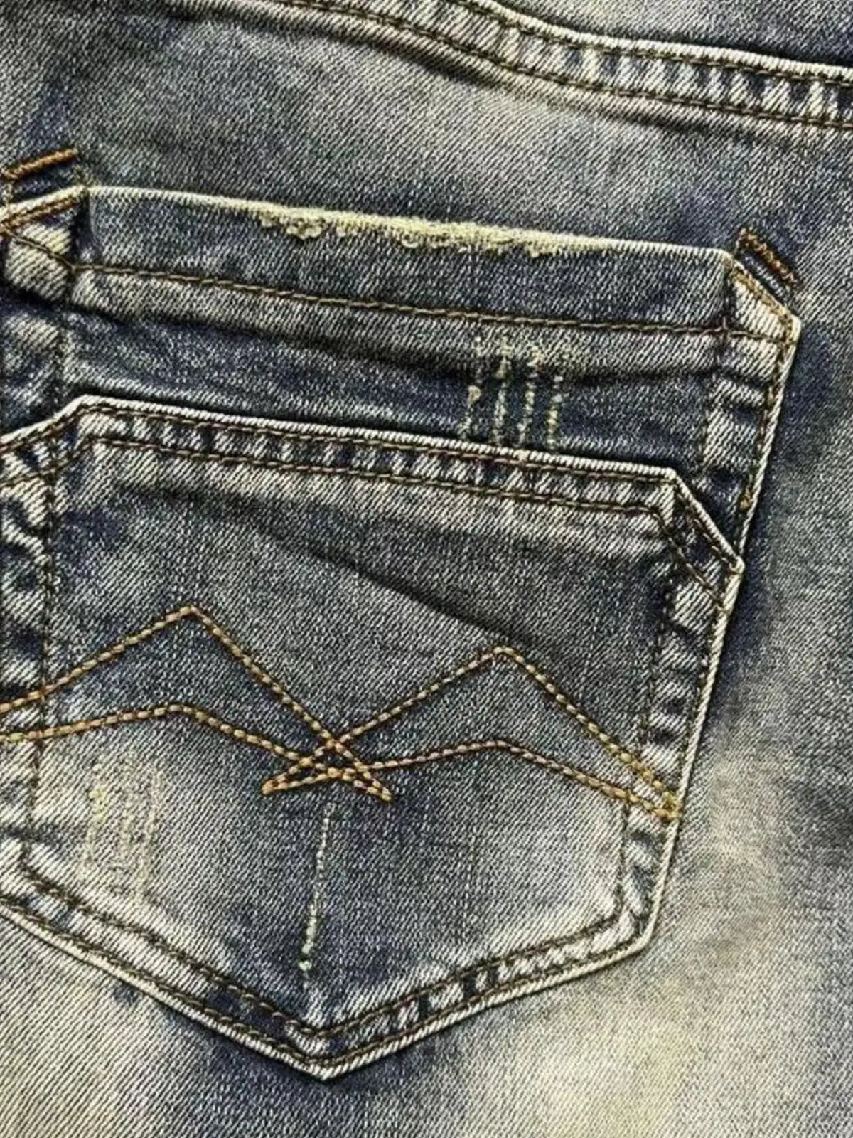 Men's washed denim stretch shorts; back pocket close-up in blue denim