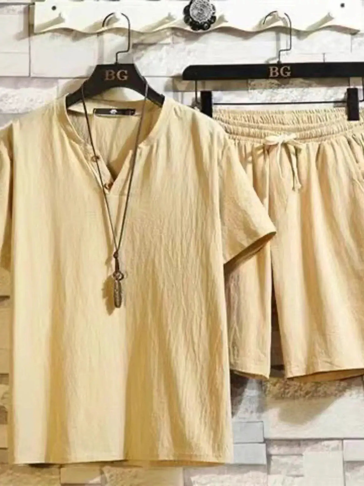 Men Plus Size Cotton Short Sleeve Matching Top And Shorts Set in beige, displayed on hangers
