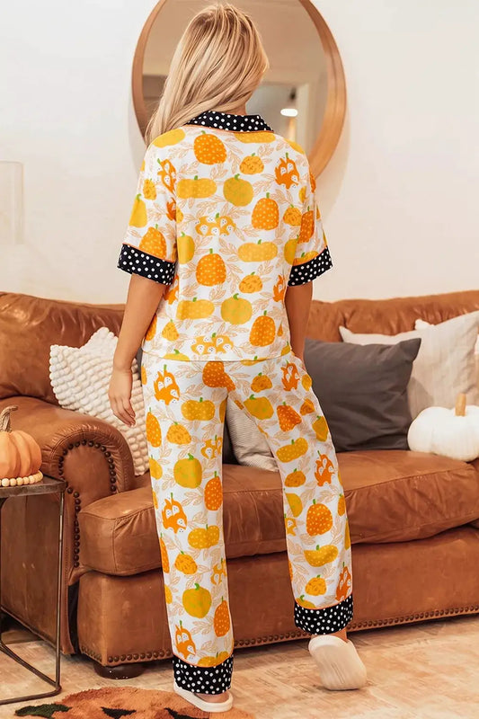 Short-sleeve pumpkin-print lounge set, 2-piece with black polka-dot trim on cuffs and pant hems; cream background