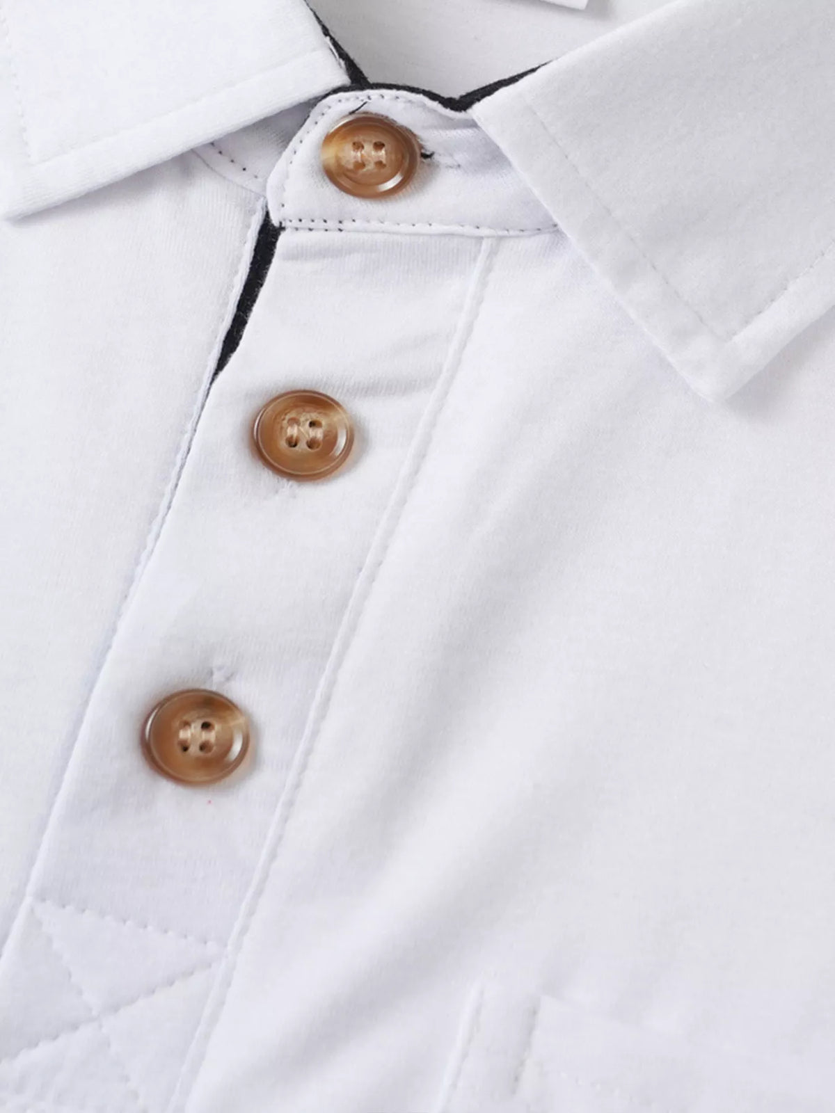 Mens white polo shirt close-up showing brown button placket, Trendsi.