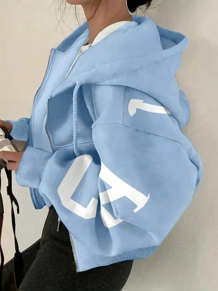 Soft full-zip light-blue hoodie sweatshirt with bold white graphic sleeve detail.