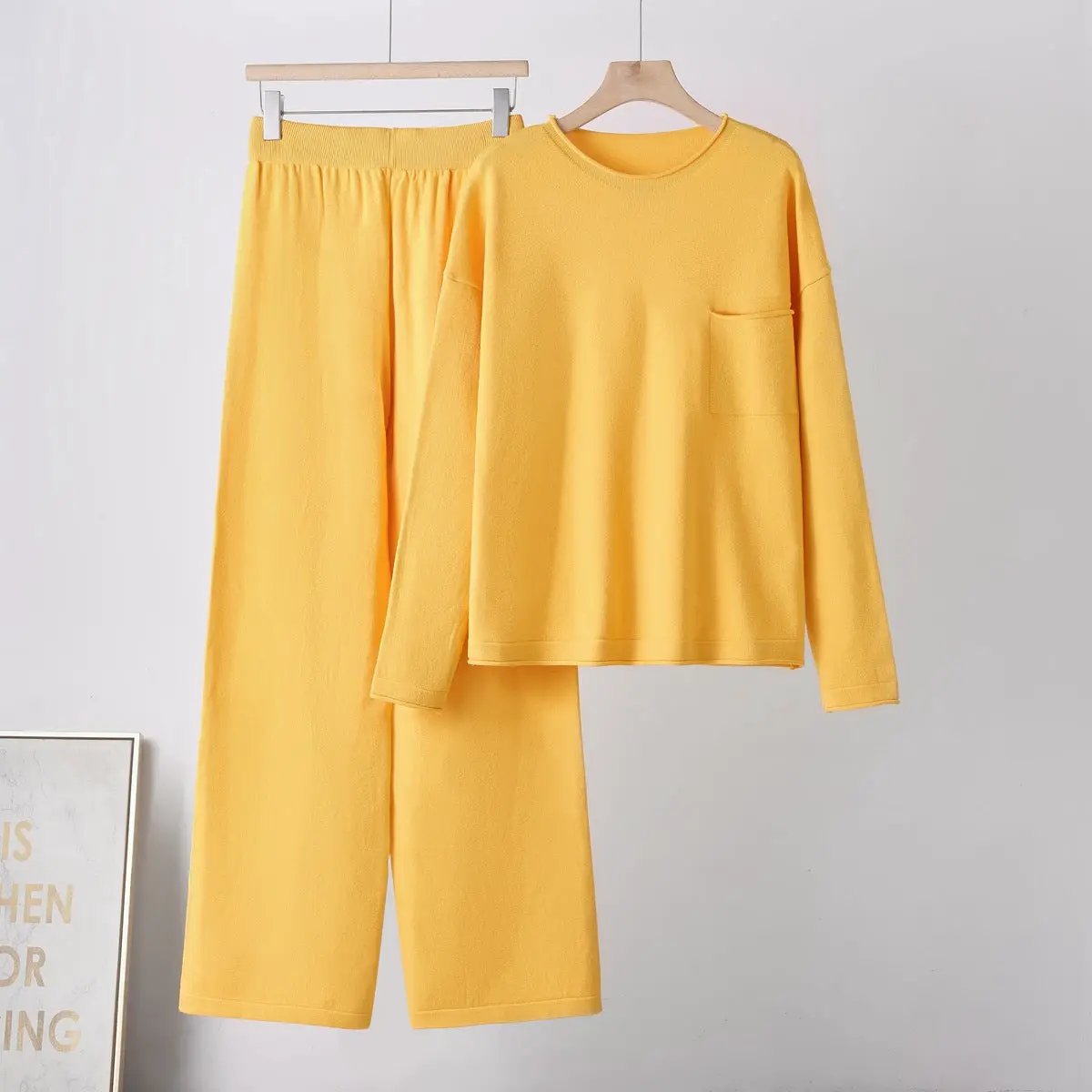 Women's yellow two-piece knit set with a long-sleeve top and wide-leg pants with pockets