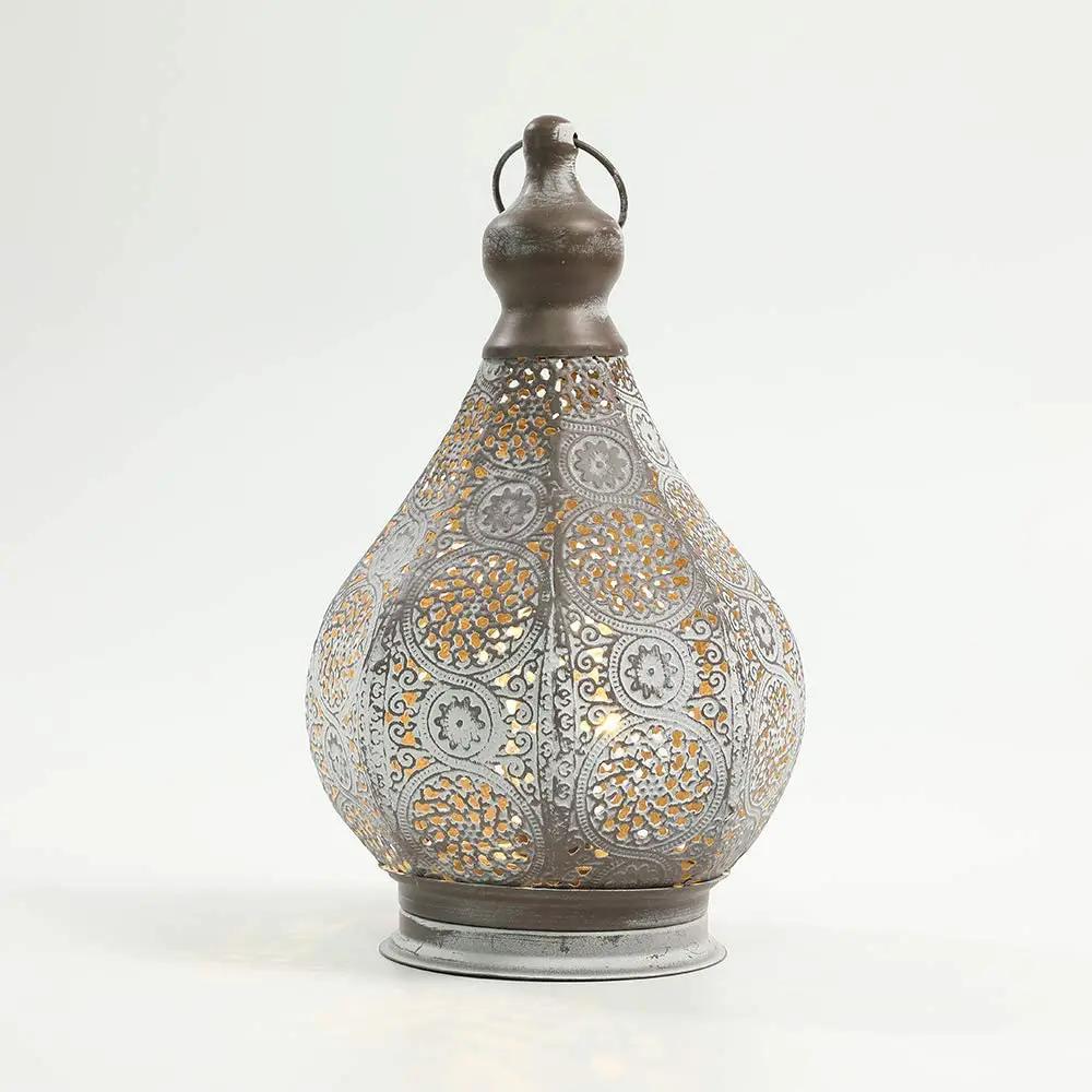 11.5'' tall battery-powered table lamp; gray metal lantern with intricate perforated pattern.