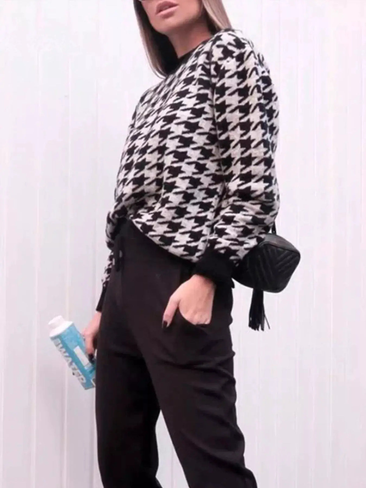 Classic oversized houndstooth sweater in black and white worn by model