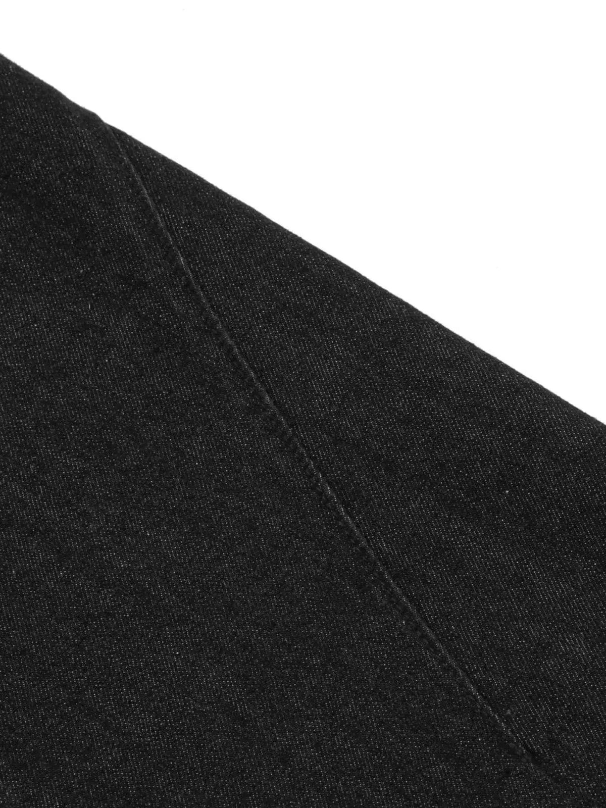 Men's denim shorts fabric close-up in dark wash with visible seam