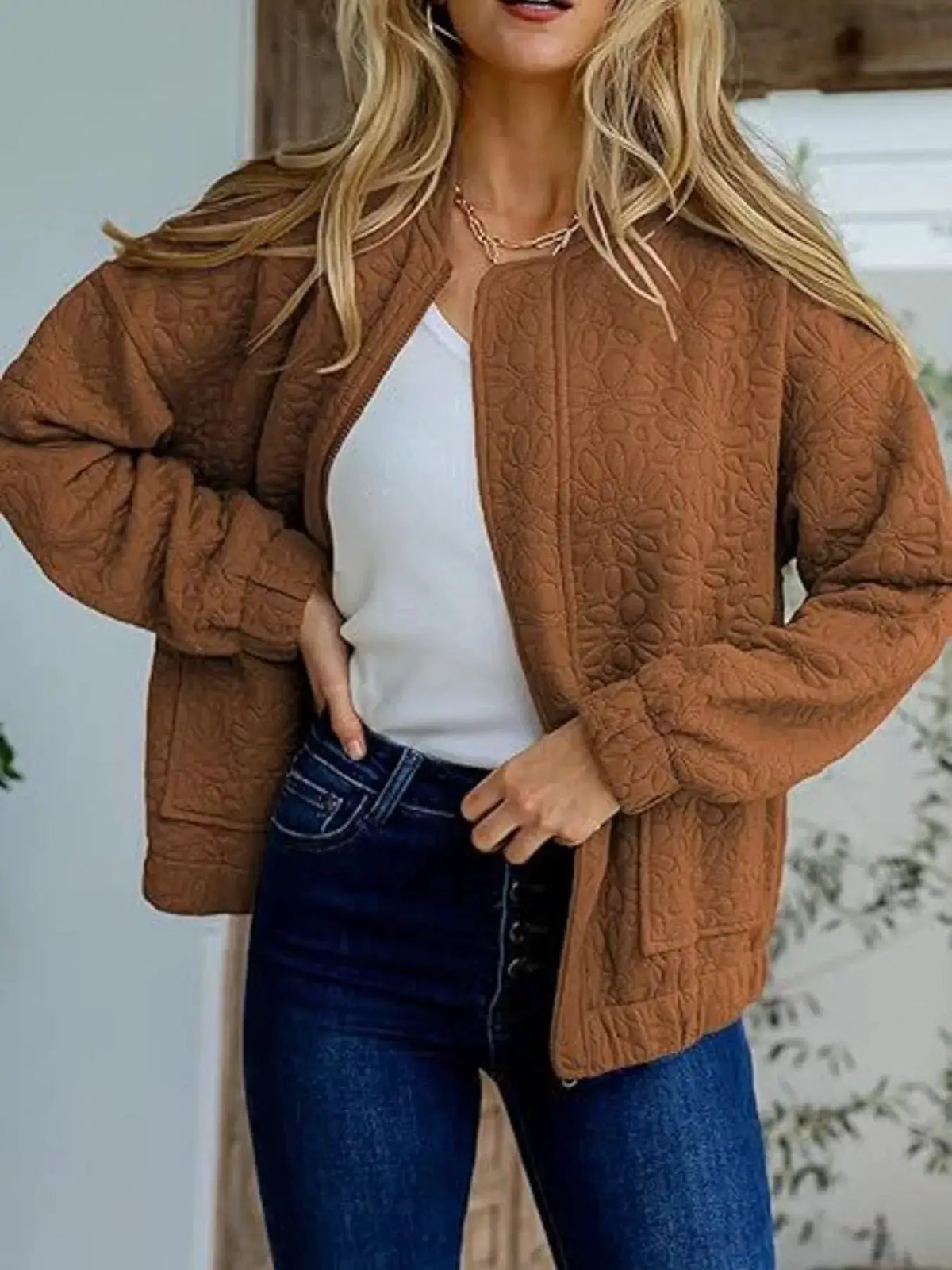 Premium floral quilted lightweight zip-up jacket in brown, worn over a white top with dark jeans