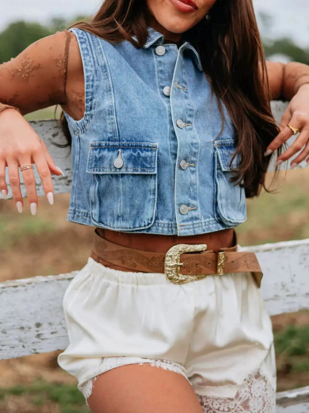 Sleeveless cropped denim vest with button front by Trendsi in a light blue wash with front pockets.