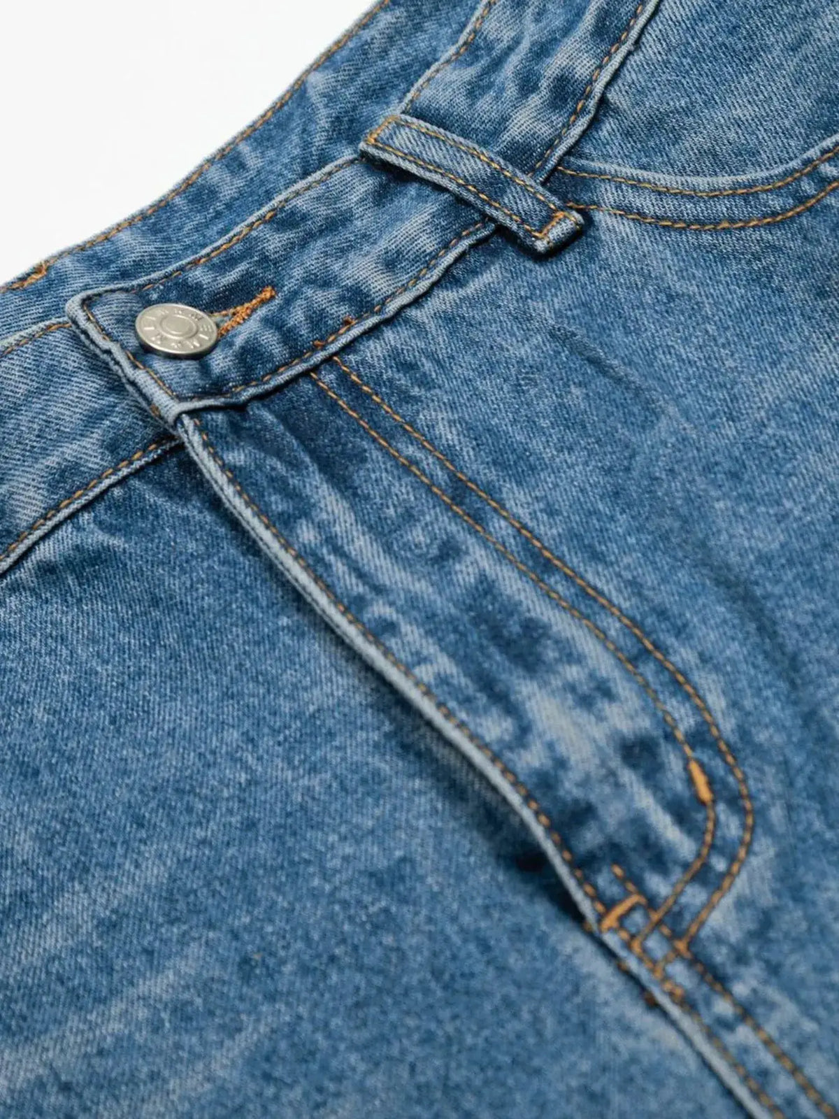 Men's relaxed-fit wide-leg washed cotton denim shorts, close-up of front pocket with metal rivet and stitching.