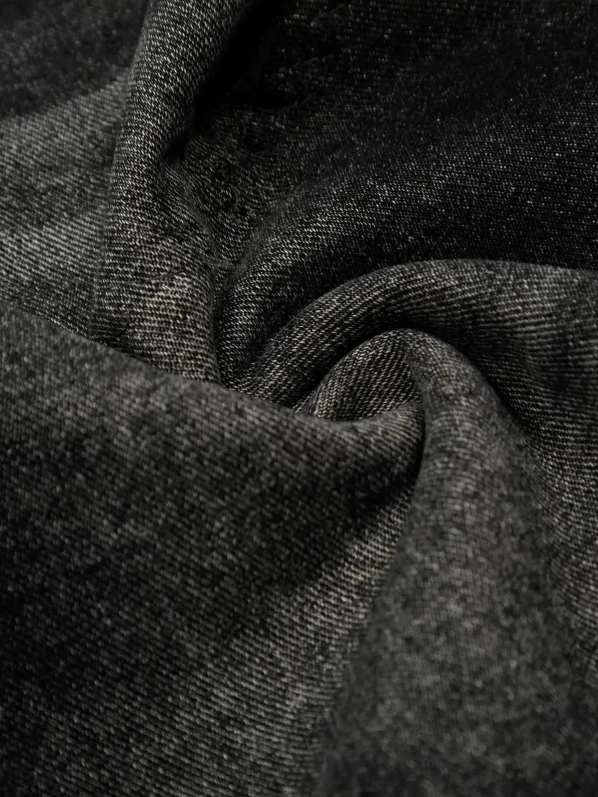Mens denim shorts fabric close-up in dark wash with textured weave