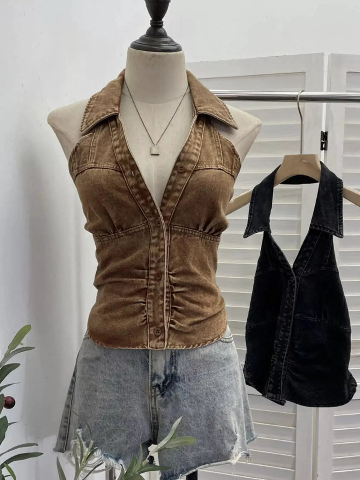 Premium textured smocked denim halter top in tan brown with front buttons on mannequin and a black denim top on hanger.