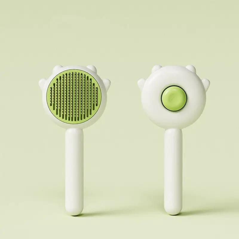 Cat comb massage grooming tool set by AdTec with two white handles and round green-accented heads.