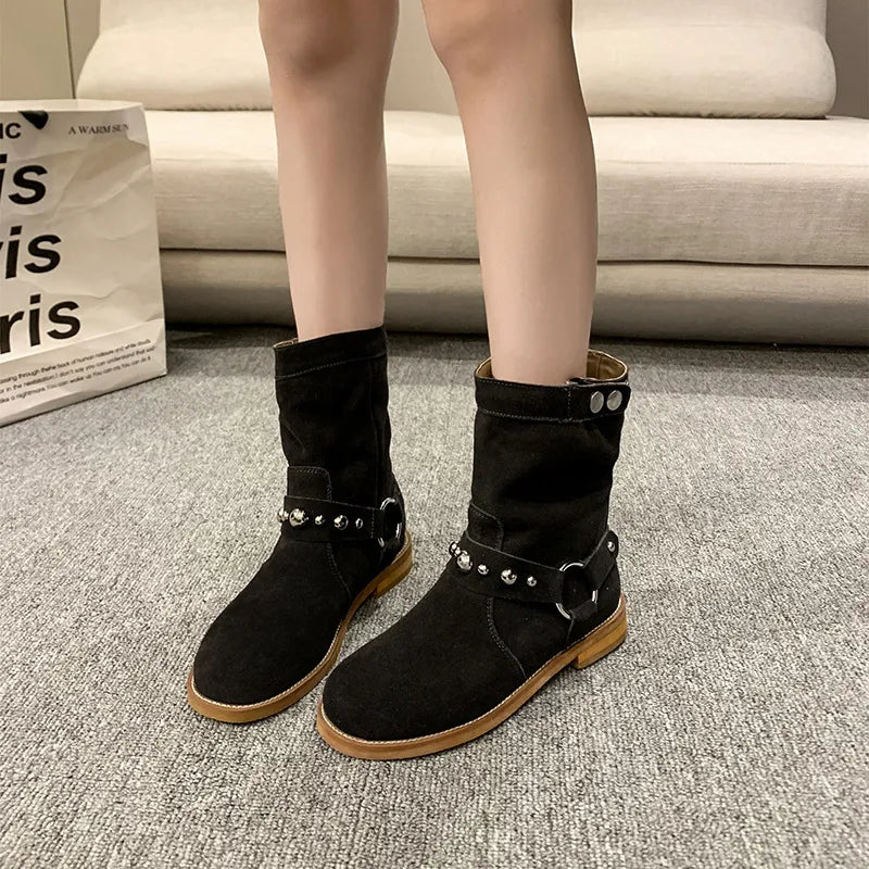 Studded suede mid-calf harness boots in black with silver-tone studs and buckles, rugged rubber outsole