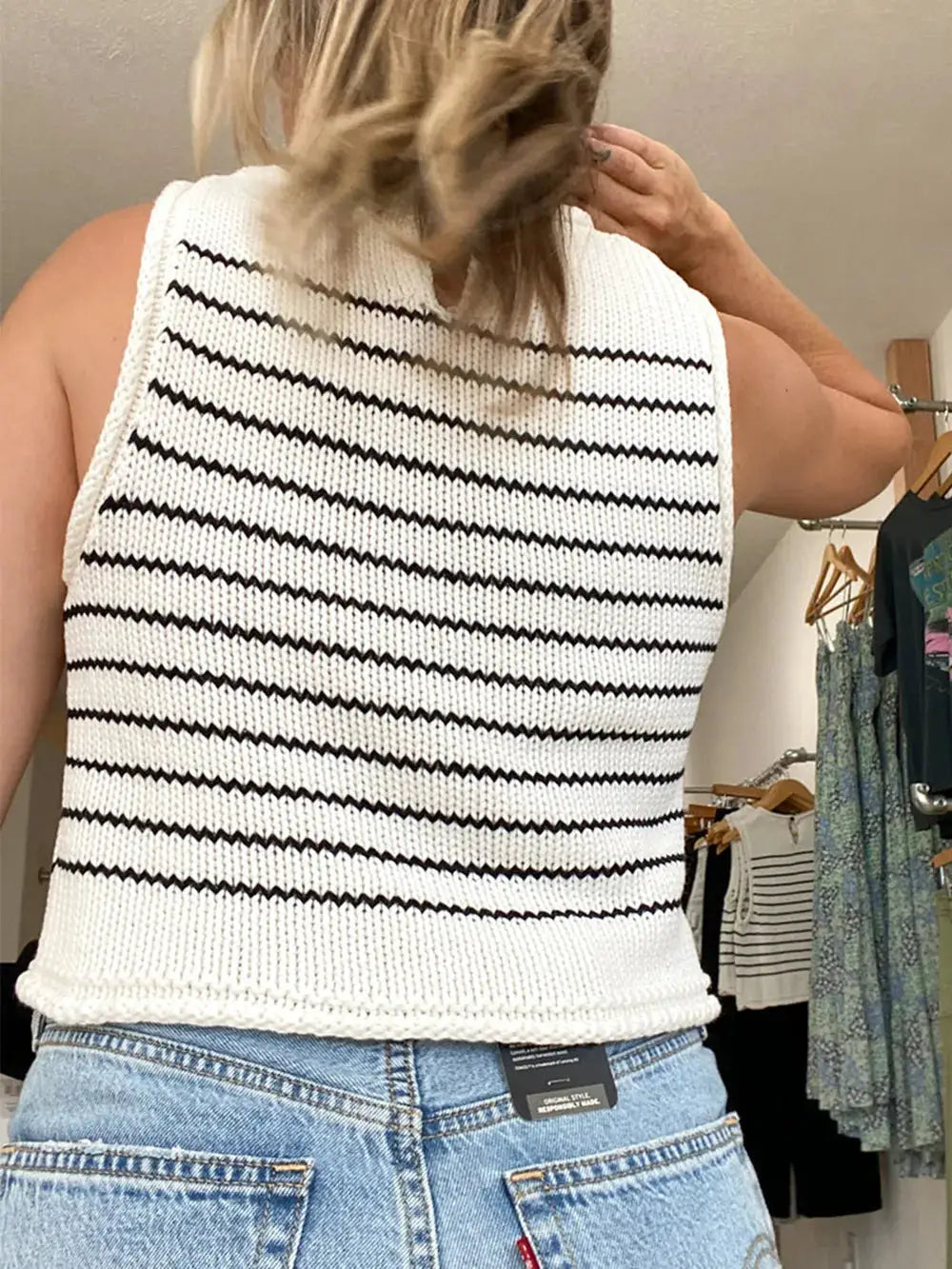 Classic striped round-neck sleeveless sweater vest in white knit with black horizontal stripes and gentle drape.